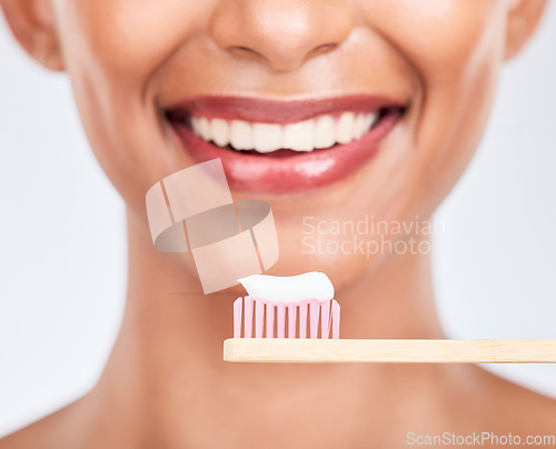 Image of Toothbrush, toothpaste and dental with woman and closeup, health and fresh breath isolated on white background. Bamboo, mouth and teeth whitening with oral care, orthodontics and routine in studio