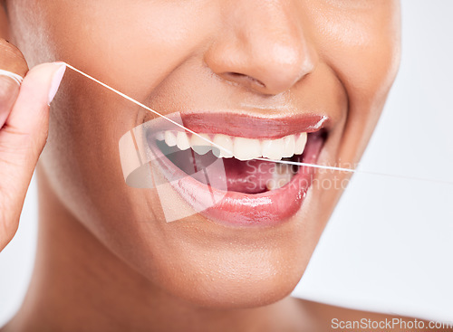 Image of Mouth, flossing and dental with woman and closeup, health and fresh breath isolated on white background. Cleaning plaque, thread and teeth whitening with oral care, orthodontics and routine in studio