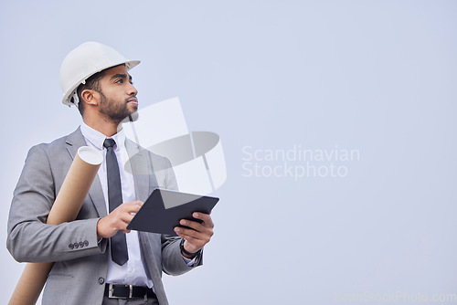 Image of Man, architect and thinking with tablet on mockup in construction planning on a studio background. Person, engineer or contractor with technology, blueprint or project plan for architecture on space