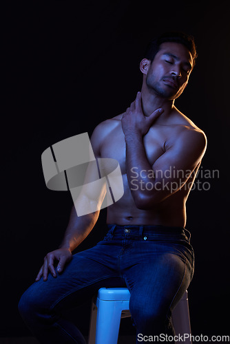 Image of Topless, sexy man on black background for fitness inspiration, beauty aesthetic or healthy fantasy. Art, strong body and seductive male model with muscle, dark studio and neon blue lighting.