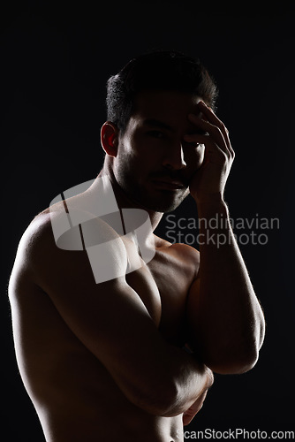 Image of Portrait, body and muscle of man in studio isolated on black background. Face, strong and serious athlete, bodybuilder and person workout, exercise or training in sports for health, power or fitness