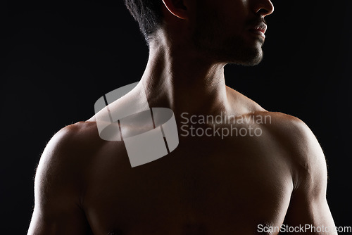 Image of Topless, muscle and sexy man in black background for fitness inspiration, beauty aesthetic or healthy body. Shadow, torso of strong male model or bodybuilder in dark studio with art lighting for gym.