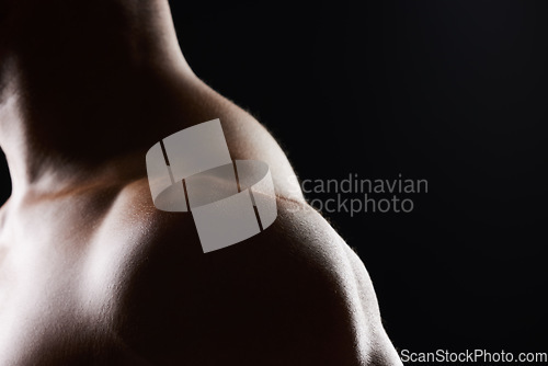 Image of Shoulder, closeup and strong muscle of man in studio isolated on black background mockup space. Body, fitness athlete and arm of model, bodybuilder power and workout for health, wellness and exercise