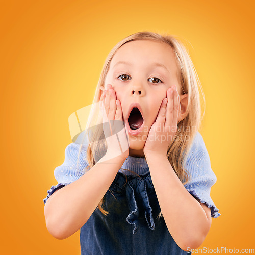 Image of Wow, surprise and hands on face of girl child in studio with news, announcement or giveaway on orange background. Omg, portrait and kid shocked by secret, gossip or drama, promotion or information