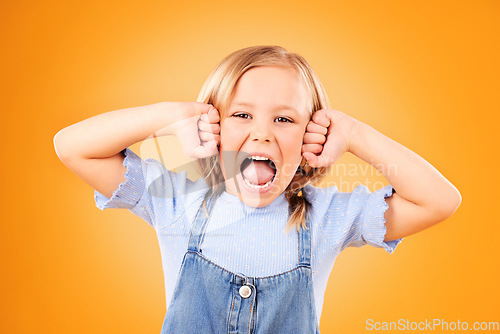 Image of Portrait, girl and kid with anger, screaming or emoji with emotion on a yellow studio background. Face, person or model with stress, frustrated or shouting with a child, facial expression or attitude