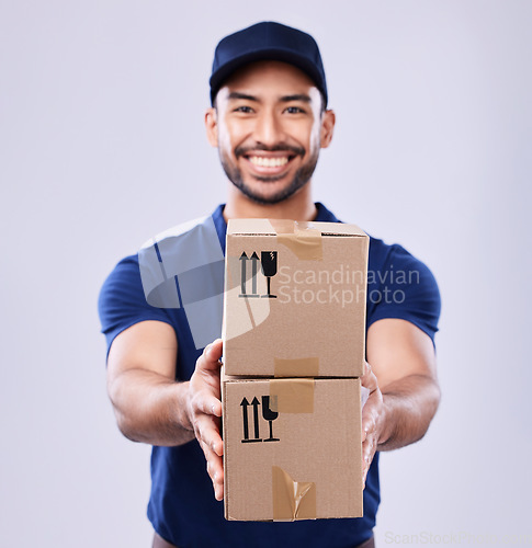 Image of Smile, portrait and delivery guy with boxes in studio, safe transport for ecommerce supplier product. Package, logistics and happy courier mail man on white background for giving sales and services.
