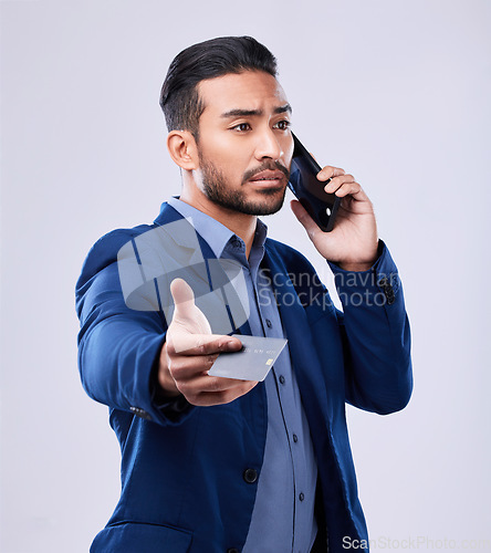 Image of Credit card, phone call and a business man in studio for communication or fintech payment. Asian person, smartphone and finance for membership subscription, account or banking info on grey background
