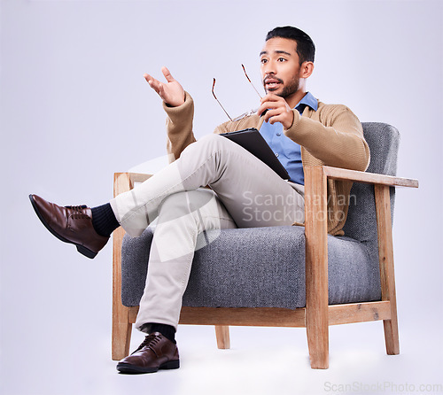 Image of Tablet, explain and a man psychologist in a chair on a white background in studio to listen for diagnosis. Psychology, mental health and information with a person counseling during a therapy session