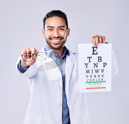 Image of Man, glasses and eye chart of optometrist in portrait at studio isolated on white background. Face, spectacles and happy ophthalmologist with snellen test document for vision, healthcare or wellness