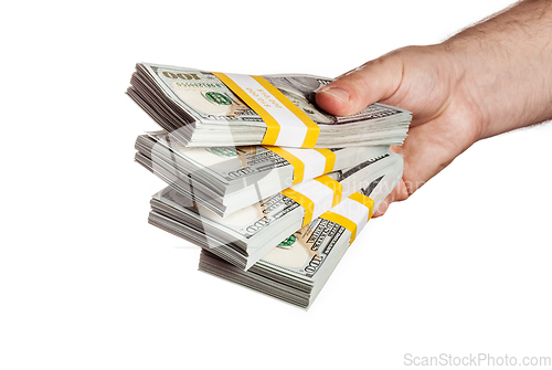 Image of Hand holding bundles of 100 USD 2013 edition bills