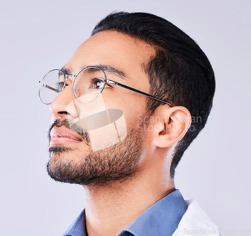 Image of Thinking, glasses and a man or doctor on a studio background for healthcare or medical vision. Medicine, idea and an Asian nurse or surgeon with a service solution or optometry on a backdrop