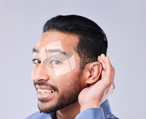 Image of Deaf, portrait and asian man with hand on cochlear in studio for speak up, listen or communication on grey background. Hearing aid, face and Japanese guy with a disability, emoji and sign for implant