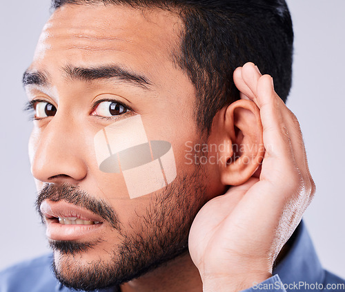 Image of Whisper, portrait and hand on ear of man in studio with speak up, listen or announcement on grey background. Gossip, face and Asian guy model with emoji for what, pardon or curious, listening or news