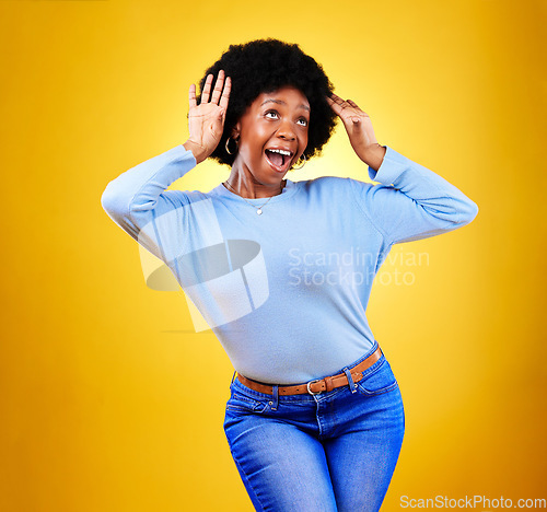 Image of Happy black woman, wow and excited winner in celebration isolated on a yellow background in studio. Smile, surprise and shocked African person in achievement success, bonus promotion and good news.