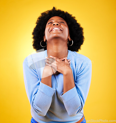 Image of Happy, excited and a young woman in studio with good news, hope and gratitude. Black person or winner on a yellow background for announcement, hands on chest and grateful for luck or self love