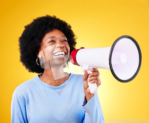 Image of Happy black woman, megaphone and voice in promotion, advertising or marketing on a yellow studio background. African female person, smile or bullhorn for loudspeaker in sale announcement or alert