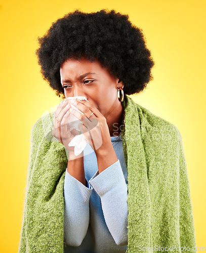 Image of Blanket, sneeze and sick woman in studio for cold, allergies or allergy of medical virus on yellow background. African model, tissue and fever of healthcare, sinusitis or bacteria of winter wellness