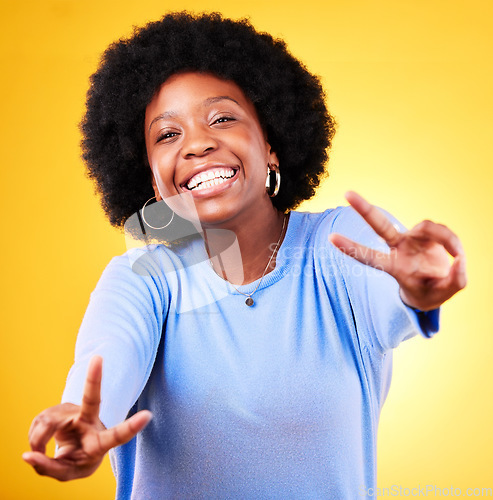 Image of Hand sign, peace and portrait of a woman in studio with fun emoji, excited face and v symbol. Happy african person on yellow background for positive mood, motivation and review with gesture or vote