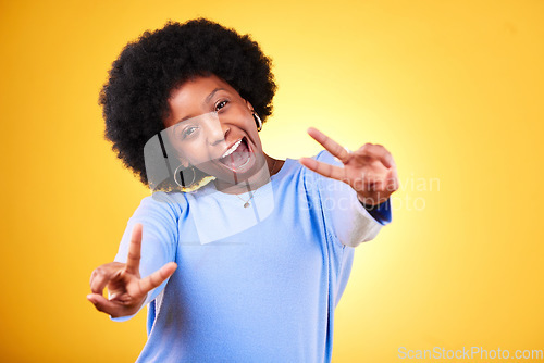 Image of Peace, hand sign and portrait of a woman in studio with fun emoji, excited face and v symbol. Happy african person on yellow background for positive mood, motivation and review with gesture or vote