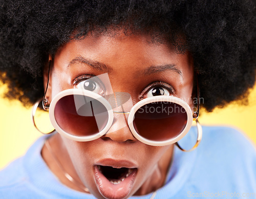 Image of Surprise, black woman and shock on face with sunglasses, fashion and crazy sale, deal or offer in studio background. Confused, portrait and African person with shocked, wow or emoji for promotion