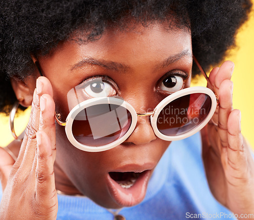 Image of Surprise, black woman and shock on face with sunglasses, fashion and crazy sale, deal or offer in studio background. Confused, face and African person with shocked, wow or emoji for promotion