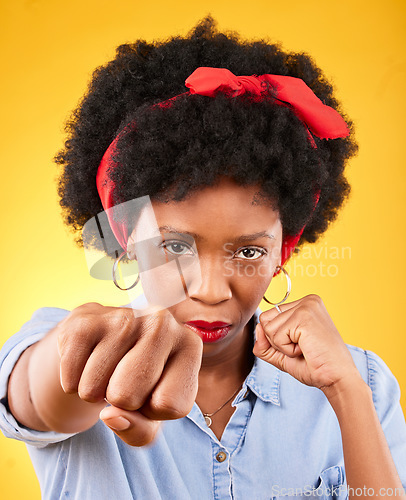 Image of Strong, fist and boxing with portrait of black woman in studio for power, motivation and energy. Empowerment, pride and champion with person on yellow background for challenge, punch and hard work