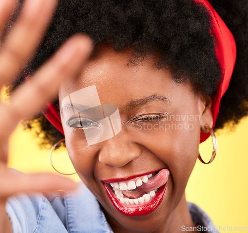 Image of Portrait, black woman or influencer taking a selfie with a crazy face or tongue out on social media. Fashion, funny wink or cool African girl taking a photo, vlog or picture on studio background