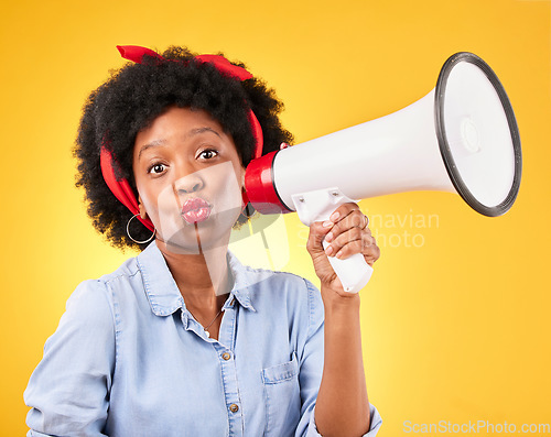 Image of Woman, megaphone and portrait for announcement, broadcast or fashion news on yellow background. Young gen z or african person with kiss face emoji and sale, voice or discount communication in studio