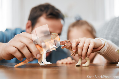 Image of Playing, dinosaur and the hands of a father and child for bonding, childhood and on a table. Closeup, together and a man, dad or kid with a toy for happiness, entertainment or family in a house