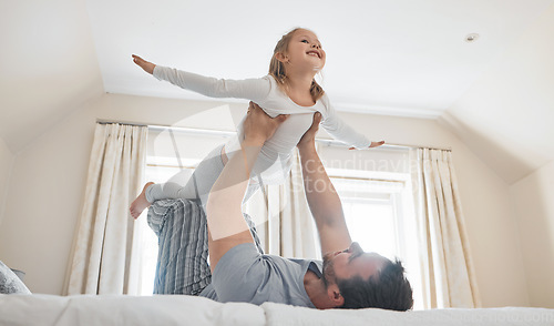 Image of Child, dad and happy on bed for airplane games, support and relax for crazy fun in house. Father, girl kid and excited to fly in bedroom for freedom, fantasy and balance for play, trust and energy