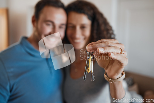 Image of Hand, success or happy couple with house keys in real estate, property investment or buying apartment. New home blur, goal or excited man with smile or woman to celebrate moving in flat together