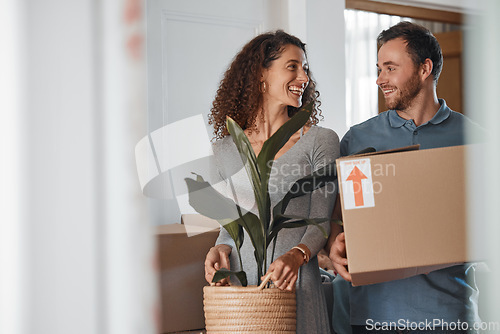 Image of Moving, new home or happy couple with boxes in real estate, property or rental apartment. Woman, proud man or excited people walking together carrying or lifting package in a house on loan with smile