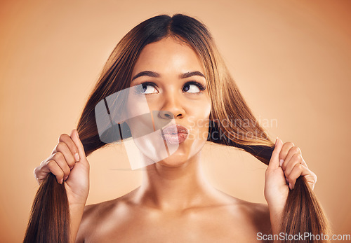 Image of Face pout, studio and woman with hair care, healthy glow and strong extensions, volume or highlights. Hairdressing salon, facial expression or model with clean shampoo hairstyle on brown background