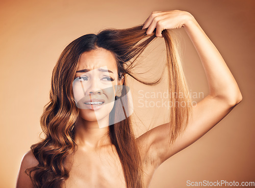 Image of Hair, problem and sad woman with damage and frustrated from salon treatment and Brazilian fail. Studio, brown background and model with crisis from split ends and upset of bad and messy haircut