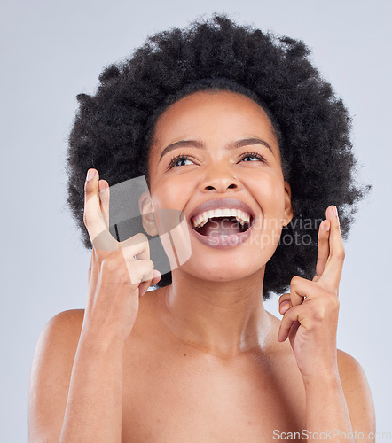 Image of Hope, luck and black woman with fingers crossed for beauty and skincare isolated in a studio gray background with smile. Notification, deal and young person excited for cosmetics with optimism