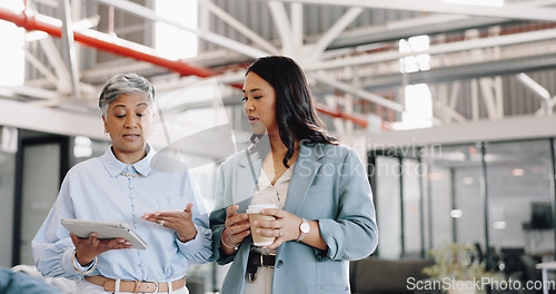 Image of Mentor, tablet and senior woman with employee, talking and walking in office for online research. Business women, administrator or mature manager in conversation for schedule on website in workplace