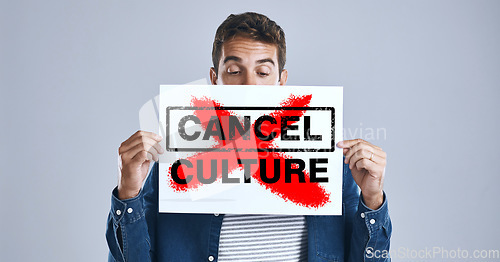 Image of Cancel culture, person and protest sign in hand with message for social media violence and support in studio. Banner, man and face with mockup space for solidarity and opinion on grey background