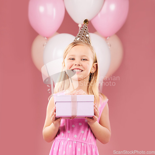 Image of Present, birthday and portrait of a child with balloons in studio for party, holiday or happy celebration. Excited girl on a pink background with gift box, hat and surprise package with a smile