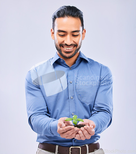 Image of Development, sustainability and businessman happy with growth isolated in a studio white background with plant. Palm, startup and entrepreneur with soil and plant as an investment or climate change