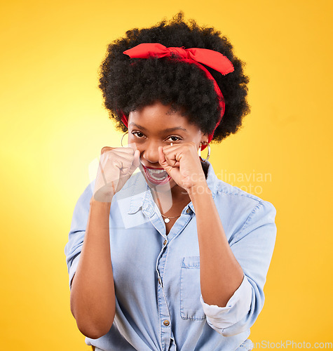 Image of Fashion, fight and boxing with portrait of black woman in studio for power, motivation and energy. Empowerment, pride and champion with person and fist on yellow background for challenge and strong