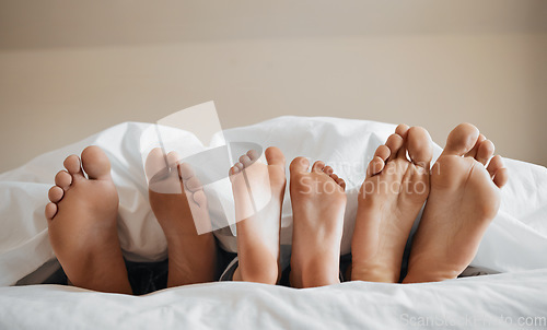 Image of Feet, parents and kid sleeping on bed to relax with love, rest or sleeping on hotel mattress in morning. People, hospitality and bedroom for child, mother and father for bonding, care or family house