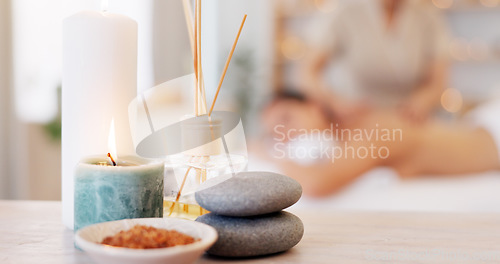 Image of Spa, rock and candle to relax in a room with atmosphere, mood or ambience in a health club. Wellness, luxury and treatment with still life objects on a table in a clinic for rest and relaxation