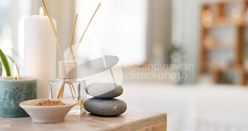 Image of Spa, rock and candle to relax in a room with atmosphere, mood or ambience in a health club. Wellness, luxury and treatment with still life objects on a table in a clinic for rest and relaxation