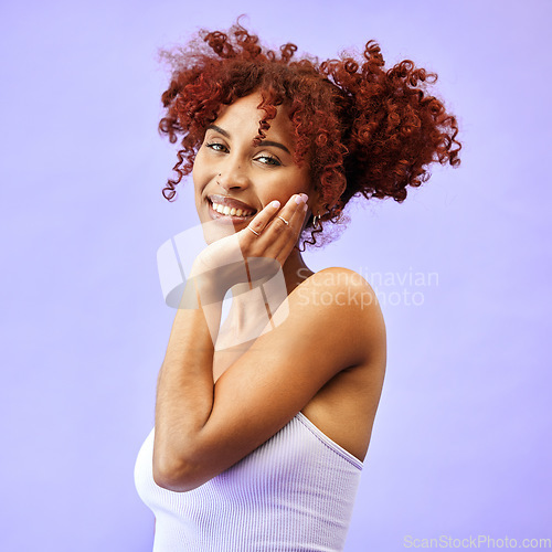 Image of Hand on face, natural beauty and woman, hair care and wellness with smile isolated on purple background. Dermatology, haircare and cosmetics, portrait with red curls and skin glow in a studio