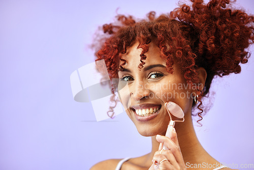 Image of Cosmetics, portrait and happy woman with rose quartz roller for massage, facial lymphatic drainage or skin routine. Stone product, mockup advertising space and studio girl on purple background