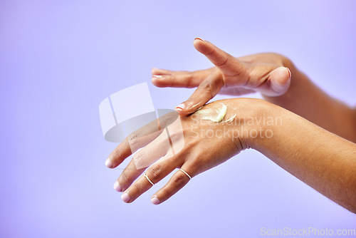 Image of Hands, dry skin and woman with cream for studio skincare, cosmetics or wellness on purple background. Bodycare, beauty or lady model with lotion, dermatology or eczema, acne or treatment application