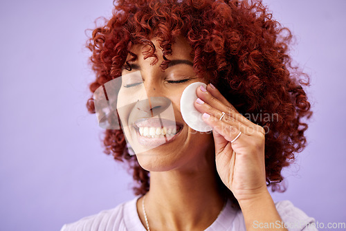Image of Happy, skincare and woman with cotton pad in studio for wellness, hydration and cosmetics on lavender background. Beauty, face and female model smile for facial, pad or cleaning with thermal water