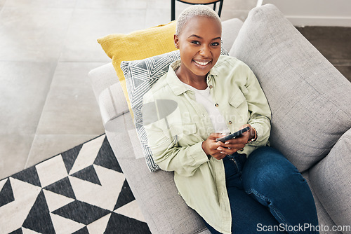 Image of Woman, portrait and relax with phone on couch for social media, text chat and contact at home from above. Happy african person, smartphone and download mobile games, digital multimedia and dating app