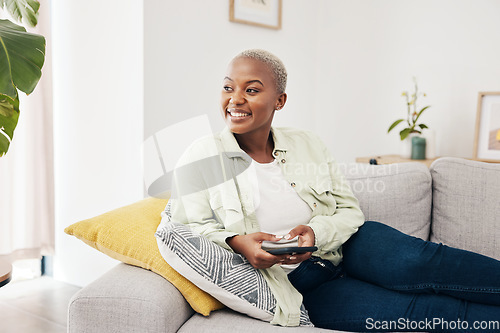 Image of Woman, happy and thinking with phone on sofa to relax with social media, digital contact and user connection. African person, smartphone and idea for mobile blog, search subscription and app at home