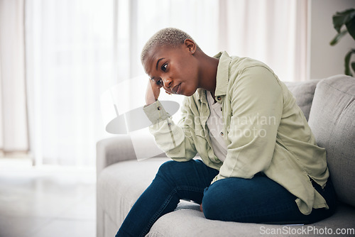 Image of Woman, thinking and anxiety on sofa for sad memory, mental health or depression of debt, crisis or fail. Frustrated, lonely and african person remember trauma of abuse, broken heart or stress at home